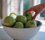 Photo of a bowl filled with green apples