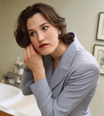 Photo of a woman putting on earrings