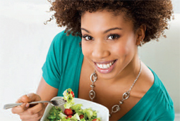 Photo of a woman eating salad
