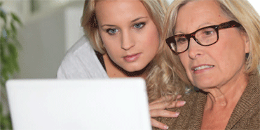 Photo of two women on a computer