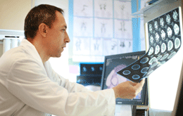 Photo of a doctor looking at the results of a MRI