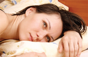 Woman laying on a pillow awake
