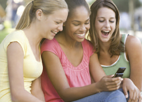 Photo of 3 girls on a cell phone