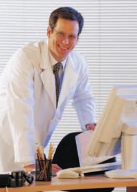 Photo of a doctor at his computer
