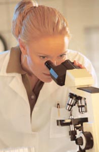 Photo of a doctor looking through a microscope