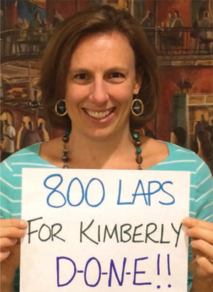 Photo of Kimberly displaying a sign