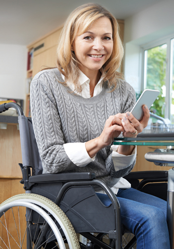 Photo of woman on phone in wheelchair in kitchen