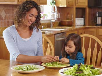 Photo of mother & daughter making salad
