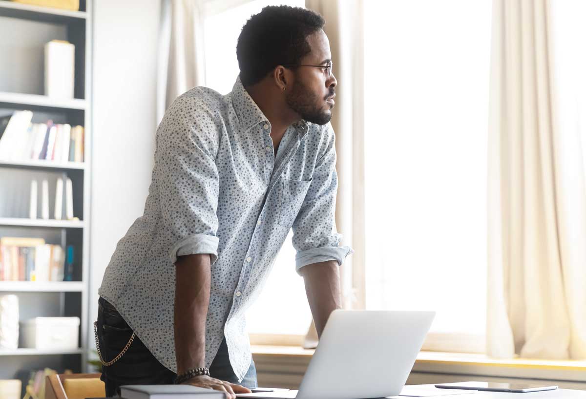 man looking out of window