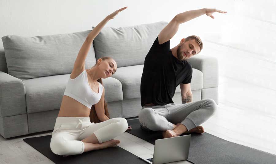 couple exercising on living room floor