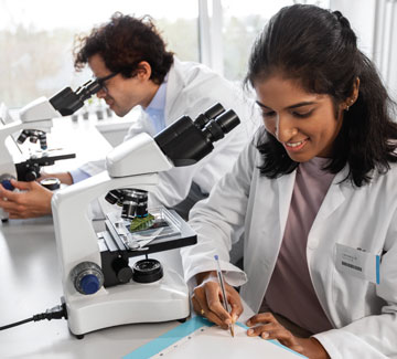 Photo of researchers with microscopes examining