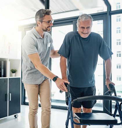 Man with walker being assisted