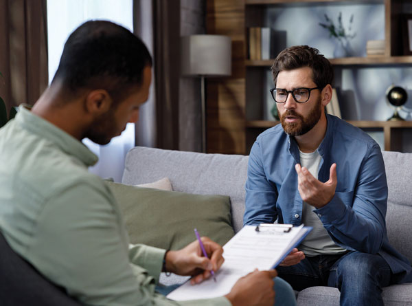 men discussing and taking notes